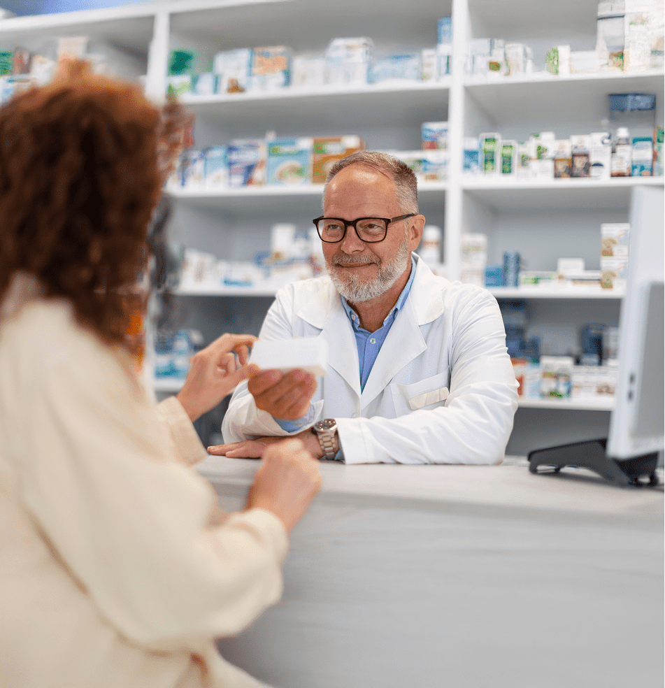 pharmacist helping patient at counter
